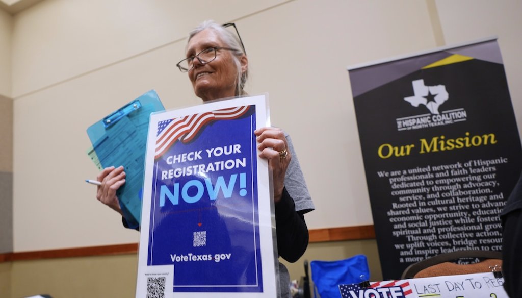 Volunteer Kathy Murphree holds a sign about voter registration during a job fair in Dallas on Jan. 14, 2026. (AP)