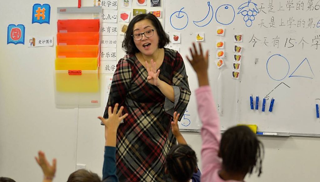 Teacher Yan Han helps students as she teaches a kindergarten class at East Voyager Academy in Charlotte.