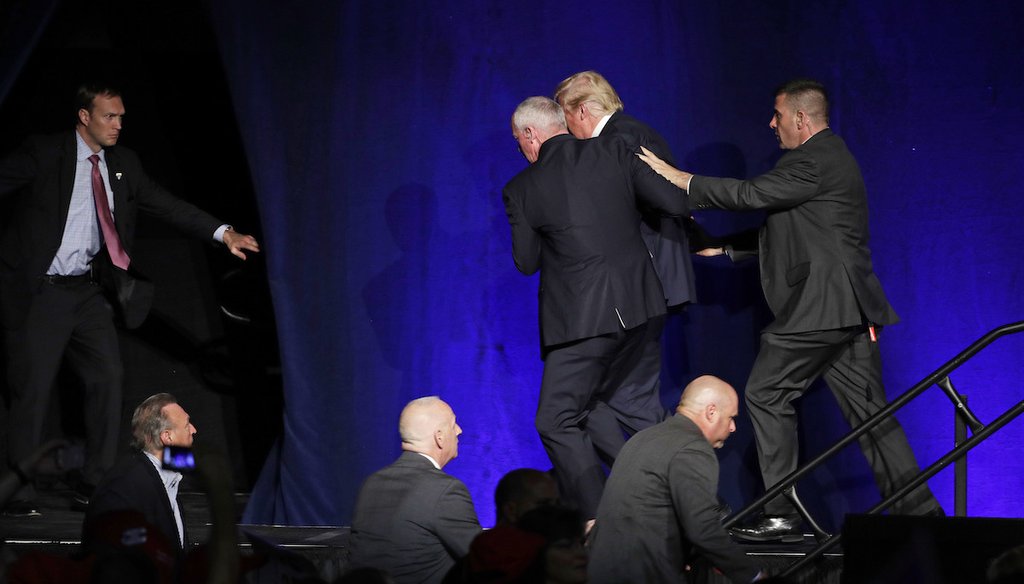 Members of the Secret Service rush Republican presidential candidate Donald Trump off the stage at a campaign rally in Reno, Nev., on Nov. 5, 2016. (AP)