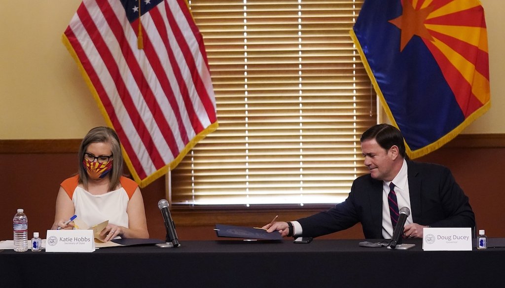 Arizona Secretary of State Katie Hobbs, left, and Arizona Gov. Doug Ducey sign election documents to certify the election results Nov. 30, 2020. (AP)