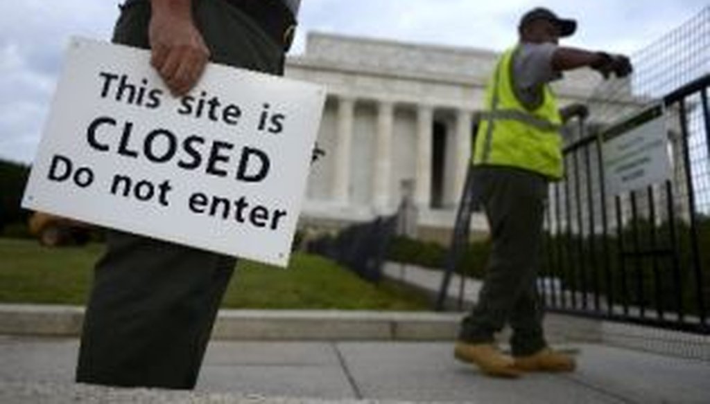 U.S. Park Service personnel erect barriers and hang signs as they close the Lincoln Memorial in Washington, on Oct. 1, 2013, the start of a federal government shutdown.