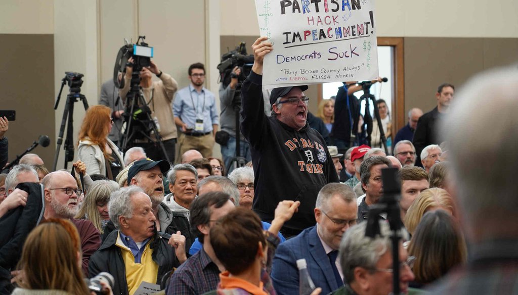 Larry Parsons, of Fenton, Mich., stands up and shouts as U.S. Rep. Elissa Slotkin speaks during a constituent forum on Dec. 16, 2019, in Rochester, Mich. (Ryan Garza, Detroit Free Press)