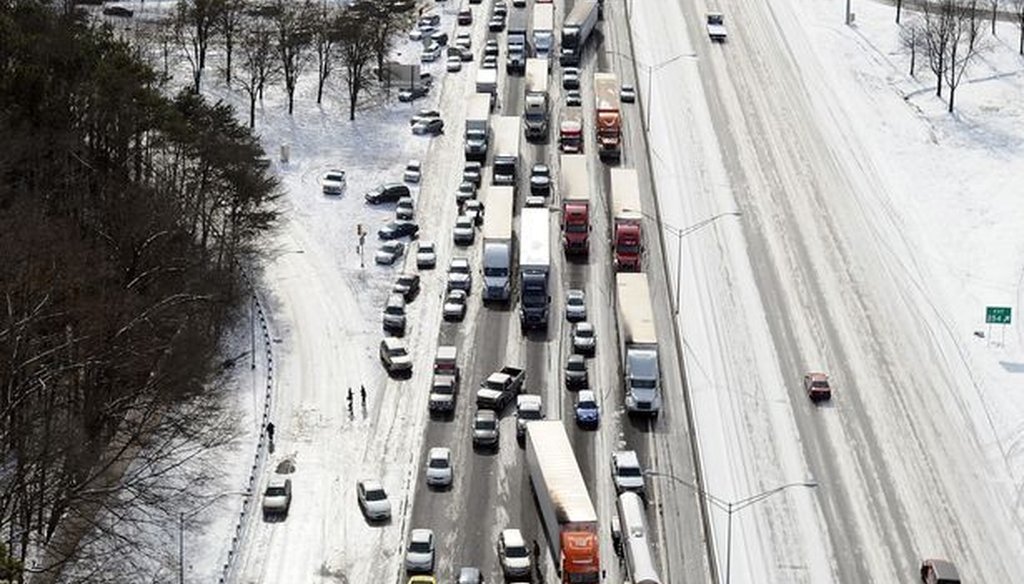In this aerial view looking at I-75 north at Moores Mill Rd., some motorists leave their vehicles along the ice-covered interstate after a winter snow storm Wednesday, Jan. 29, 2014, in Atlanta. Photo credit: David Tulis/AP.