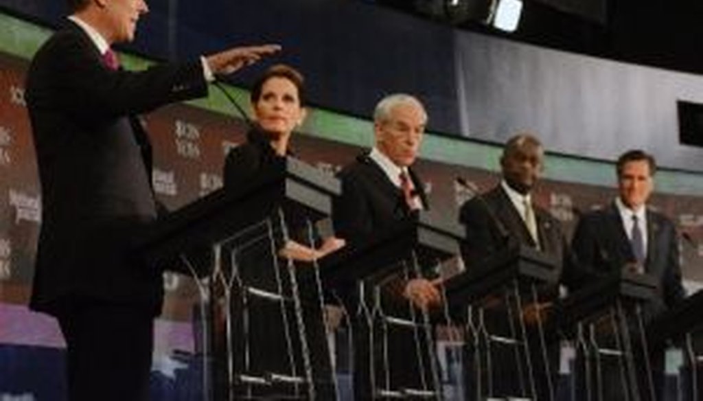 Republican presidential candidates Jon Huntsman, Michele Bachmann, Ron Paul, Herman Cain, and Mitt Romney, listen during the CBS News/National Journal foreign policy debate on Saturday, Nov. 12, 2011, in Spartanburg, S.C. 