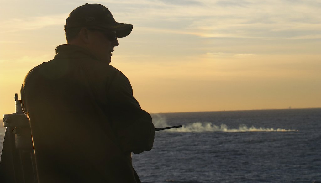 U.S. Navy Cmdr. Brad A. Fancher, commanding officer of the USS Carter Hall (LSD 50), observes the debris field of a high-altitude surveillance balloon Saturday, Feb. 4 2023, off the coast of South Carolina. (Jerry Ireland/U.S. Navy via AP)