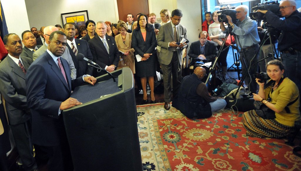 Atlanta Mayor Kasim Reed, standing at the microphone, takes a question from a reporter during a March 7, 2013 press conference to announce a deal with the Atlanta Falcons on a $1 billion stadium.