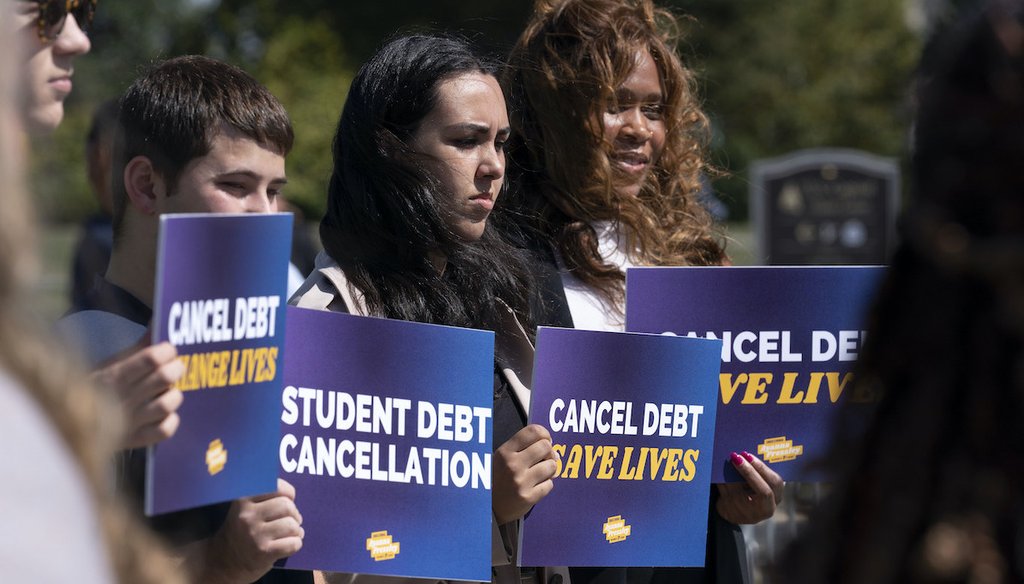 Activists hold signs during a news conference on student debt cancellation on Capitol Hill in Washington, Thursday, Sept. 29, 2022. (AP)