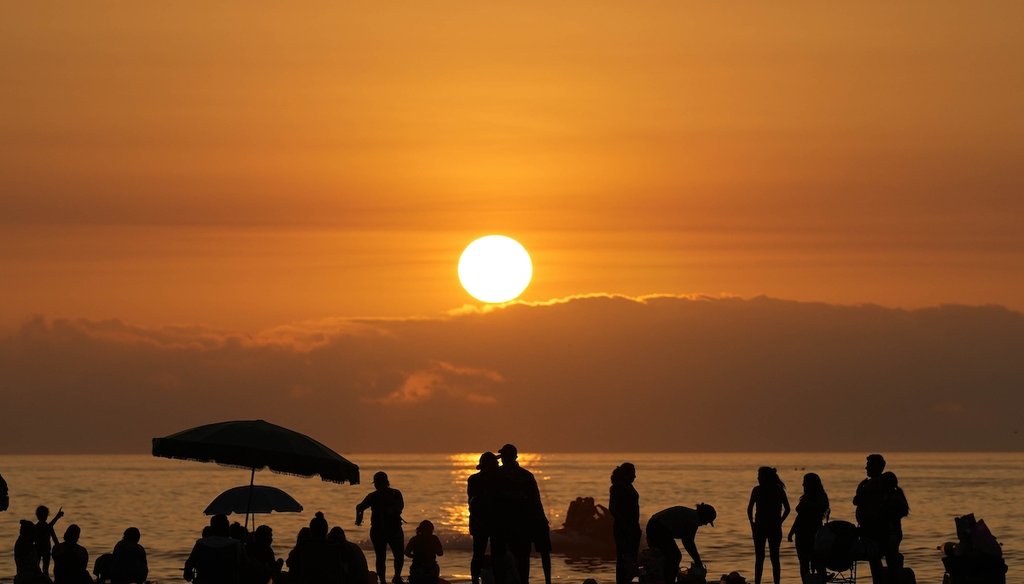People gather at Sombrilla beach to watch the sunset, in Lima, Peru, Wednesday, Jan. 24, 2024. (AP)