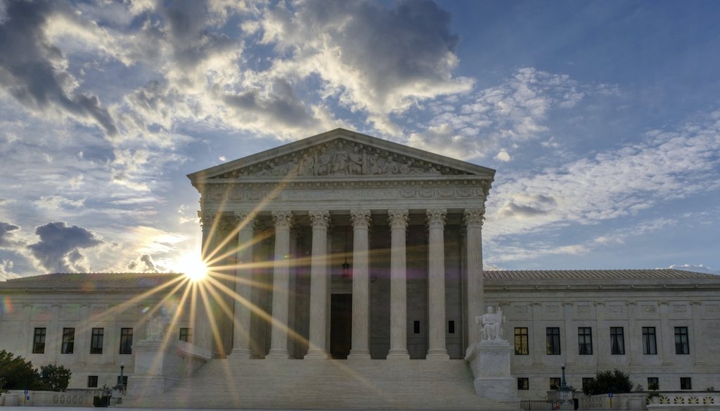 The sun flares in the camera lens as it rises behind the U.S. Supreme Court building in Washington, Sunday, June 25, 2017. (AP)