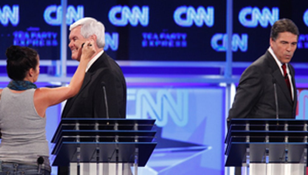 Newt Gingrich has his makeup retouched during a commercial break for the Sept. 12, 2011 CNN/Tea Party Express GOP debate in Tampa.