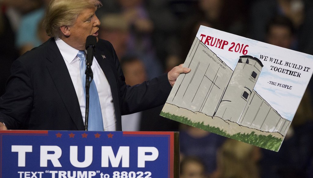 Donald Trump holds a sign from a supporter during a rally Wednesday, March 9, 2016 at the Crown Coliseum in Fayetteville, N.C. (via The News & Observer)