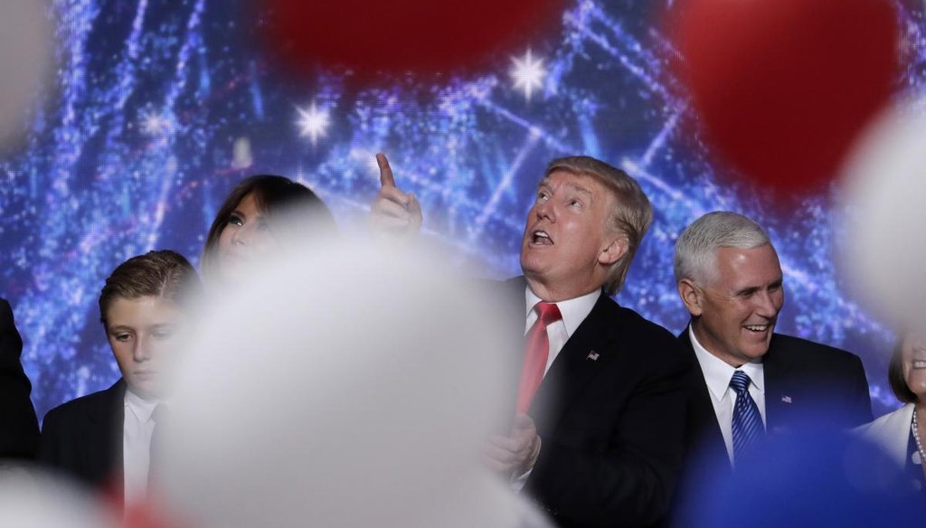GOP presidential nominee Donald Trump looks up at the falling balloons as he stands on the stage with his family and his running mate Indiana Gov. Mike Pence of Indiana after delivering his acceptance speech at the RNC in Cleveland. (AP)
