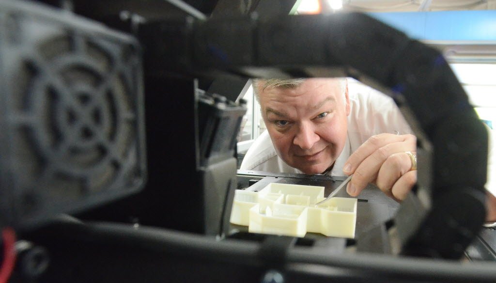 A lab program coordinator at Gateway Technical College in Sturtevant, Wis., shows how a pick is used to scrape away excess resin on 3D prints. The Wisconsin Democratic Party claims state Republicans are funding tech schools at 1989 levels.