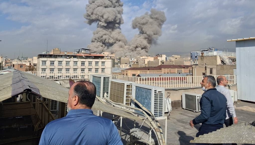 People watch as smoke rises on the skyline after an explosion in Tehran, Iran, Feb. 28, 2026. (AP)