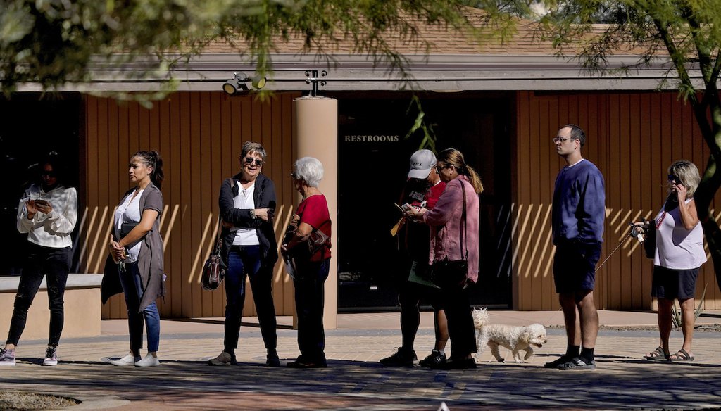 Voters wait in line outside a polling station, Nov. 8, 2022, in Tempe, Ariz. (AP)