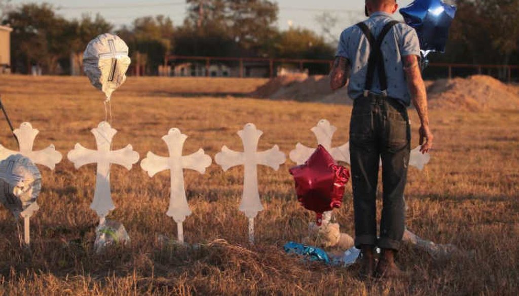 Derrick Bernaden of San Antonio, Texas visits a memorial where 26 crosses stand in a field on the edge of town to honor the 26 victims killed at the First Baptist Church of Sutherland Springs. (Getty Images)