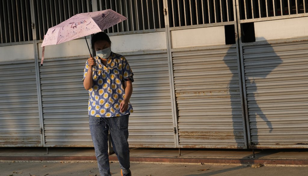 A woman holds an umbrella to shelter from the sun in Bangkok, Thailand, April 22, 2023. A heat wave in parts of southern Asia in April this year was at least 30 times more likely by climate change, according to a study released Wednesday, May 17. (AP)
