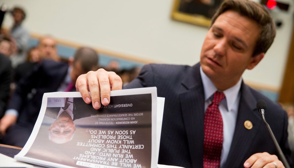 Then-Rep. Ron DeSantis looks through a packet with a photograph of IRS Commissioner John Koskinen on the front on Tuesday, May 24, 2016. (AP)