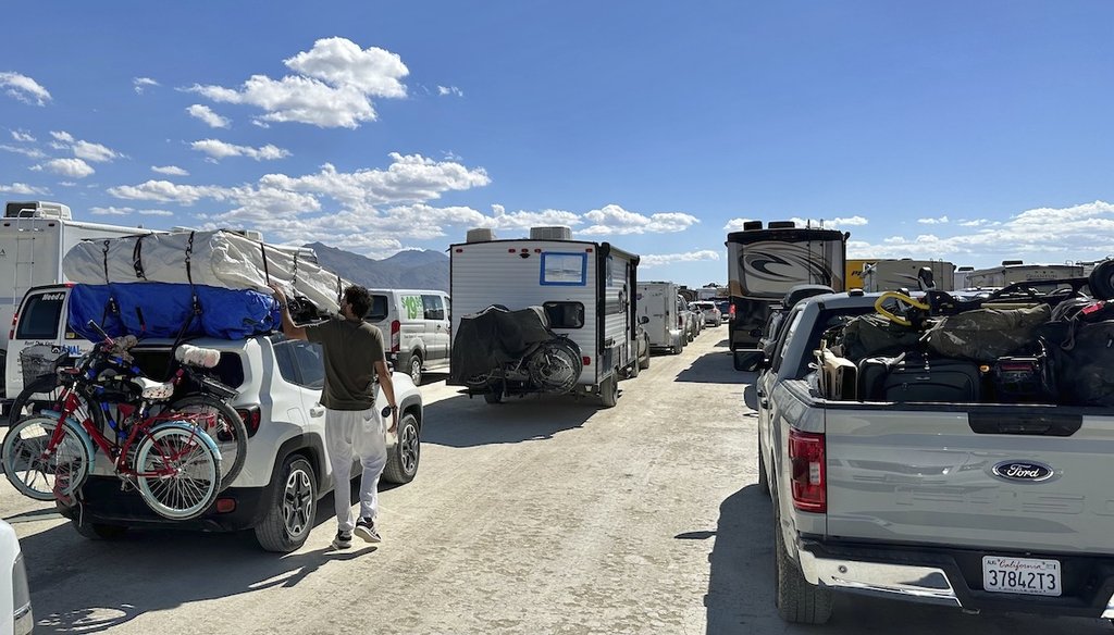 People leave the Burning Man festival in Nevada on Sept. 5, 2023. The traffic jam leaving Burning Man eased up considerably Tuesday as the exodus from the mud-caked Nevada desert entered another day. (AP)