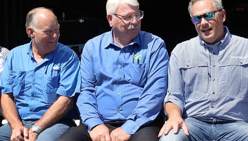 From left, state Senator Bret Jackson and Commissioner of Agriculture Steve Troxler chat with Lt. Gov. Dan Forest during a rally with farmers on Tuesday, July 10, 2018 at Joey Carter's farm in Duplin County near Beulaville, N.C.