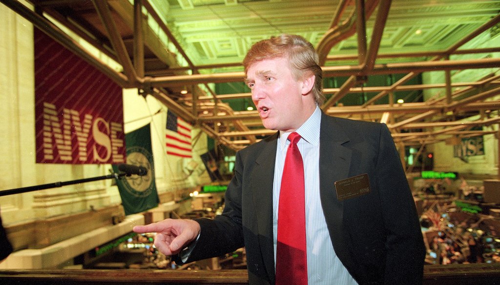 Former President Donald Trump poses for photos above the floor of the New York Stock Exchange on June 7, 1995.