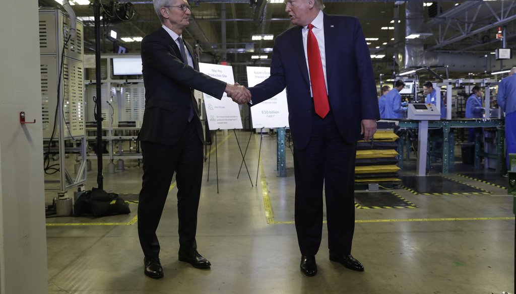 Apple CEO Tim Cook and President Donald Trump shake hands during a tour of an Apple manufacturing plant in Austin. (AP Photo/ Evan Vucci)