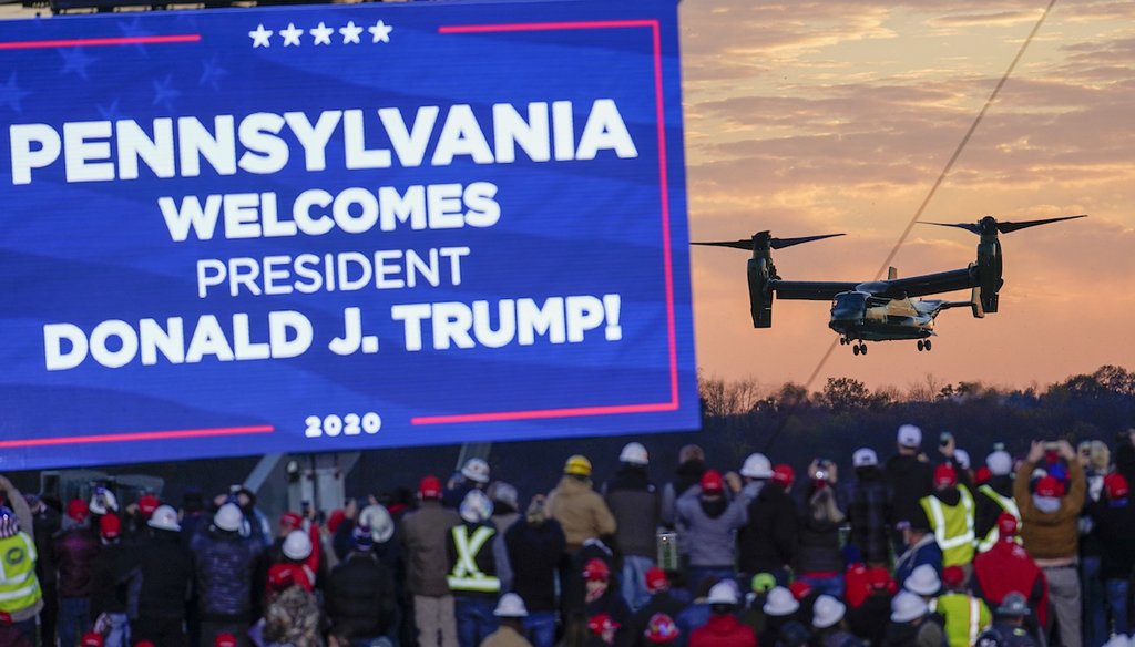 The crowd watches one of the three Osprey aircraft escorting Marine One as it arrives for a campaign stop by President Donald Trump, Saturday, Oct. 31, 2020, at the Butler County Regional Airport in Butler, Pa. (AP Photo/Keith Srakocic)