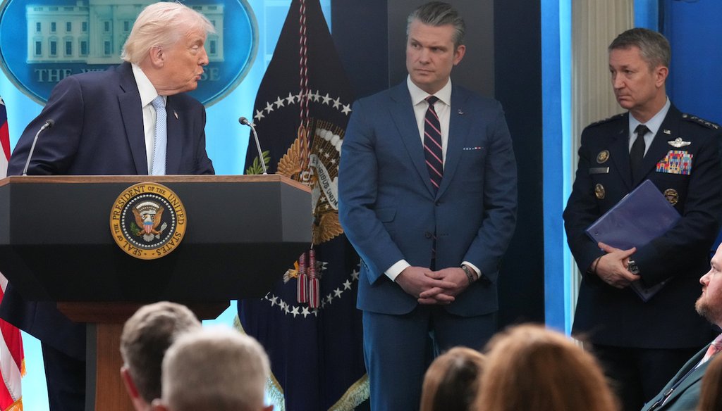 President Donald Trump looks to Defense Secretary Pete Hegseth and Chairman of the Joint Chiefs of Staff Gen. Dan Caine as he speaks with reporters during a news conference in the James Brady Press Briefing Room at the White House, April 6, 2026,