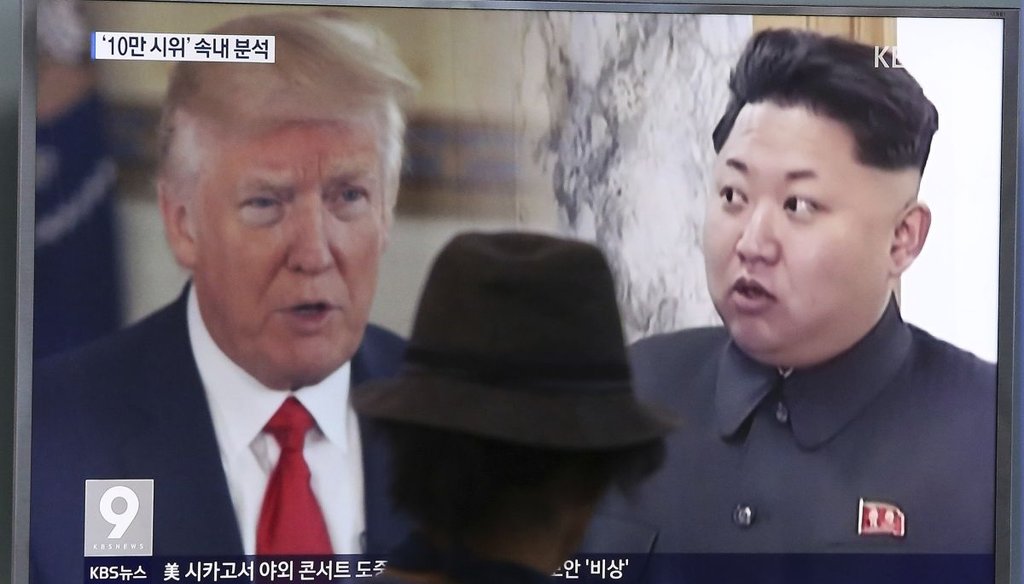 A South Korean channel broadcasts images of President Donald Trump and Kim Jong Un.