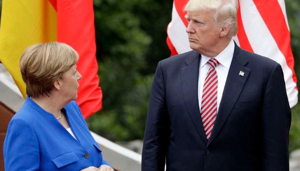 German Chancellor Angela Merkel, left, speaks with President Donald Trump during a group photo at the G7 Summit in Taormina, Italy, on May 26, 2017. (AP/Andrew Medichini)