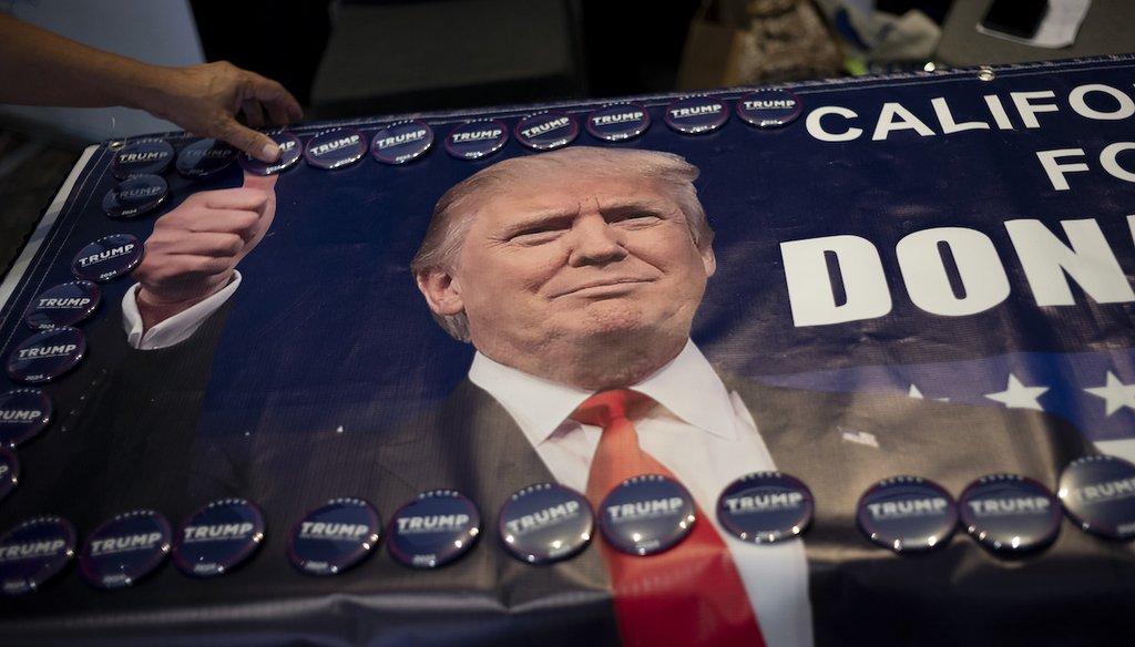 An attendee grabs a campaign button supporting former President Donald Trump at the California Republican Party Convention in Anaheim, Calif., Saturday, Sept. 30, 2023. (AP)