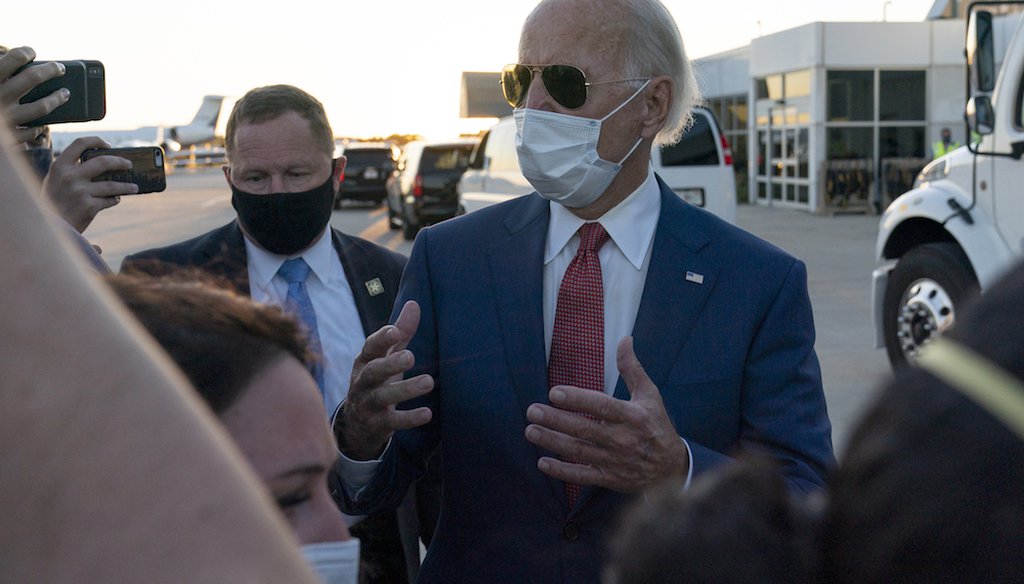 Democratic presidential candidate Joe Biden speaks to reporters as he walks to board his plane in Milwaukee, Wis. (AP Photo/Carolyn Kaster)
