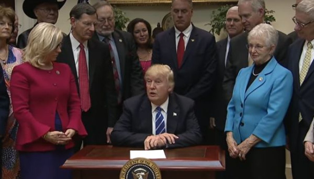 Donald Trump signs legislation rolling back federal regulations on March 27, 2017.
