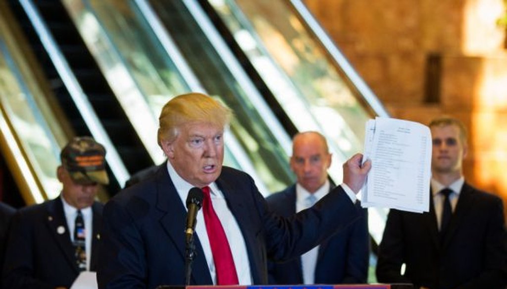 Donald Trump holds a list of charities during a news conference he called to discuss money he pledged to veterans' causes at Trump Tower in New York City, May 31, 2016. (Damon Winter/The New York Times)
