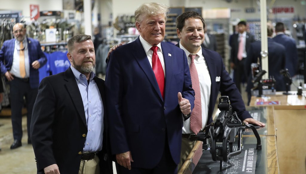 Former President Donald Trump visits the Palmetto State Armory and takes a picture with owners Jamin McCallum and Julian Wilson in Summerville, S.C., Monday, Sept. 25, 2023. (AP)