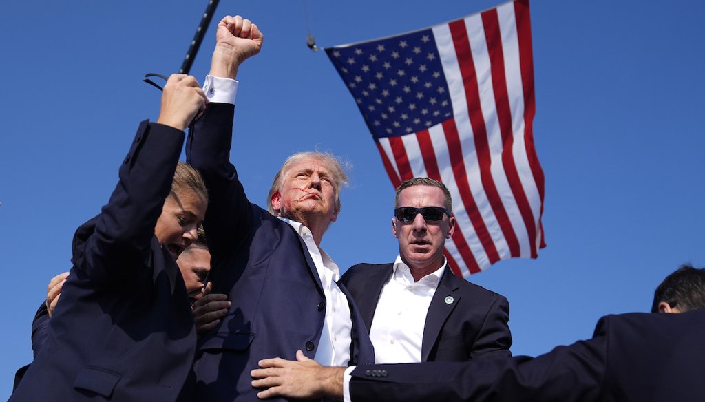 FILE — Republican presidential candidate former President Donald Trump is surrounded by U.S. Secret Service agents at a July 13 campaign rally in Butler, Pennsylvania, following an attempted assassination. (AP Photo/Evan Vucci, File)