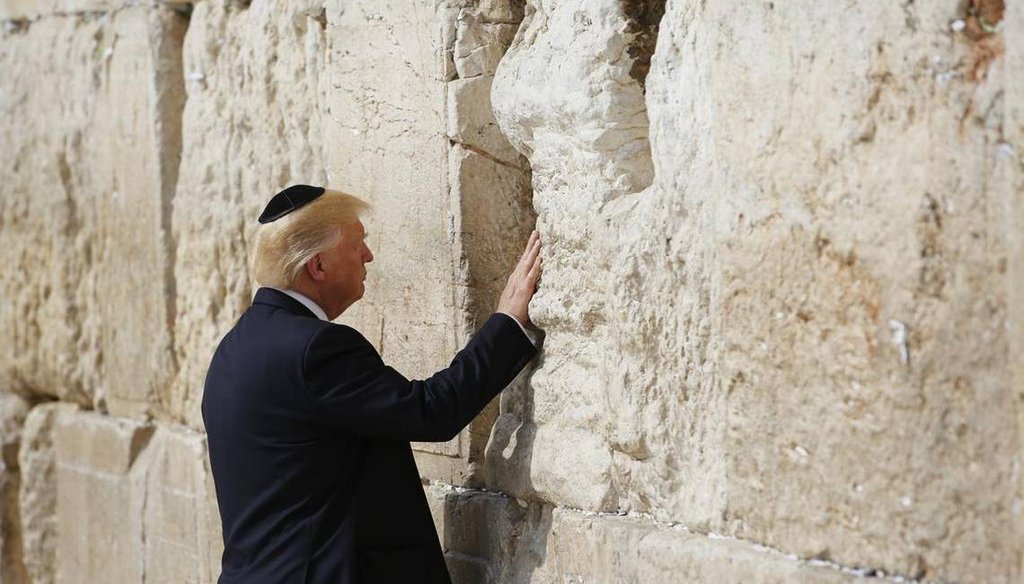 President Donald Trump touches the Western Wall, Judaism’s holiest prayer site, in Jerusalem’s Old City, May 22, 2017. (AP)
