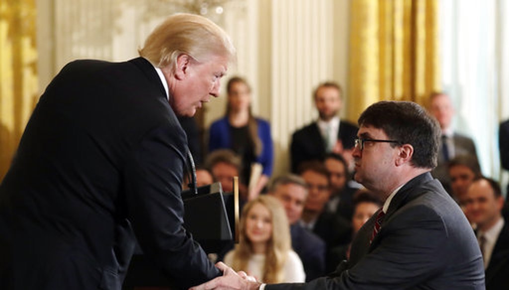 President Donald Trump shakes hands with Acting Veterans Affairs Secretary Robert Wilkie, during an event on prison reform in the East Room of the White House May 18, 2018, in Washington. (AP)