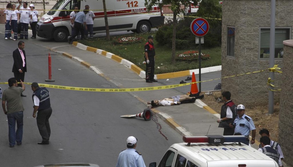 An unidentified man lies on the ground lifeless after an attack outside of the U.S. Consulate in Istanbul, Turkey, Wednesday, July 9, 2008. (AP)