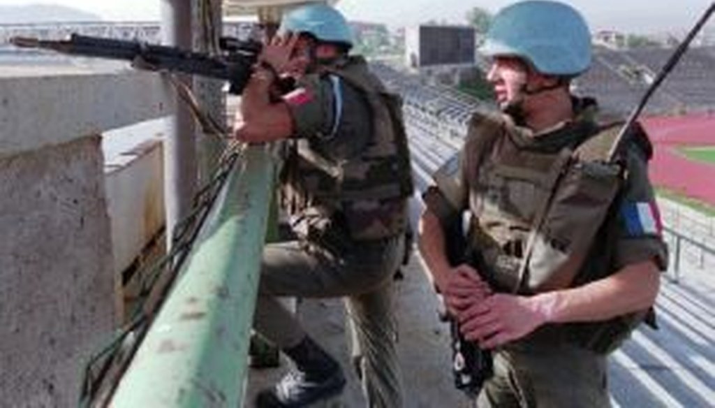 Two French peacekeepers from an anti-sniper unit take positions in Sarajevo's Olympic stadium on Sept. 27, 1994, attempting to suppress sniper fire in and around the war-torn capital of Bosnia-Herzegovina.