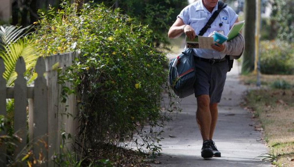 Mail carrier Derek Wilkins makes deliveries on Burlington Ave. N. in St. Petersburg, Fla. (Lara Cerri/Tampa Bay Times)