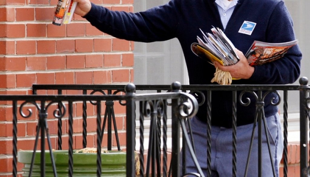 Russ Fox, a letter carrier for the U.S. Postal Service, delivers mail in Wichita, Kan. (Associated Press)