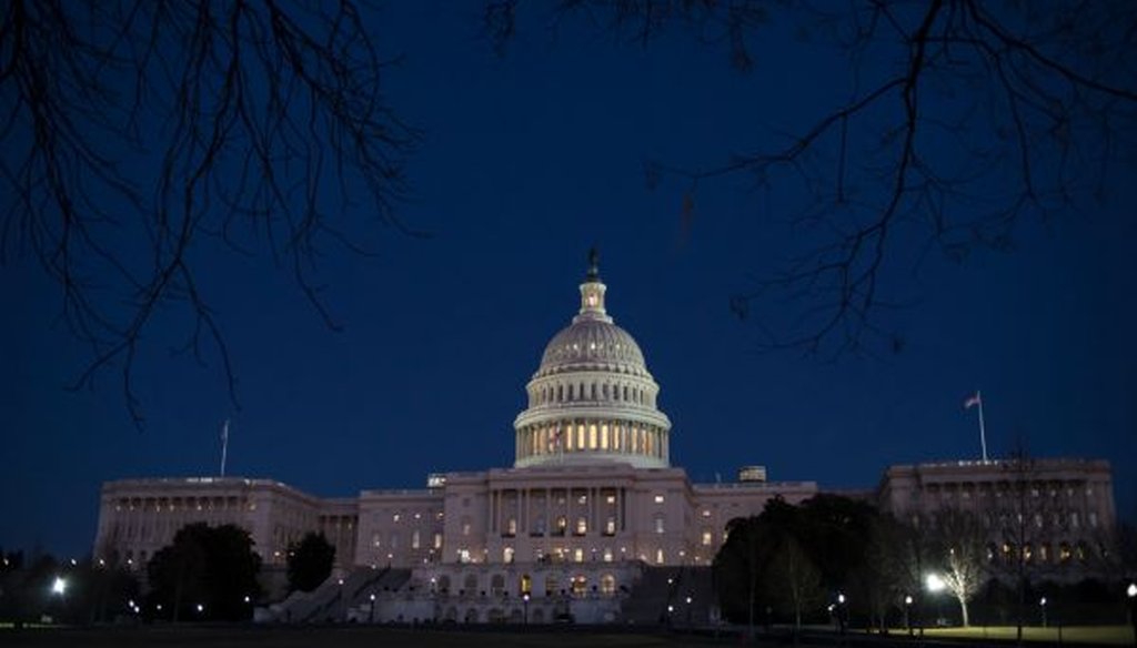The U.S. Capitol is illuminated on Jan. 19, 2018. (AP/J. Scott Applewhite)