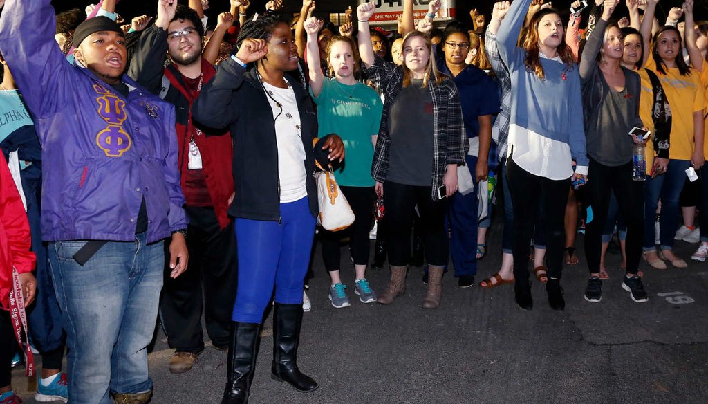 University of Oklahoma students gather outside the now closed University of Oklahoma's Sigma Alpha Epsilon fraternity house during a rally in reaction to members of the fraternity captured on video chanting a racial slur. (AP)
