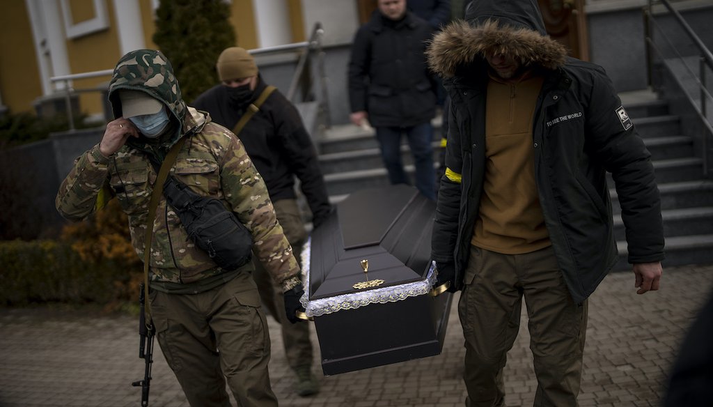 Militia men carry the coffin with the body of Volodymyr Nezhenets, 54, during his funeral in the city of Kyiv, Ukraine, March 4, 2022. (AP Photo)