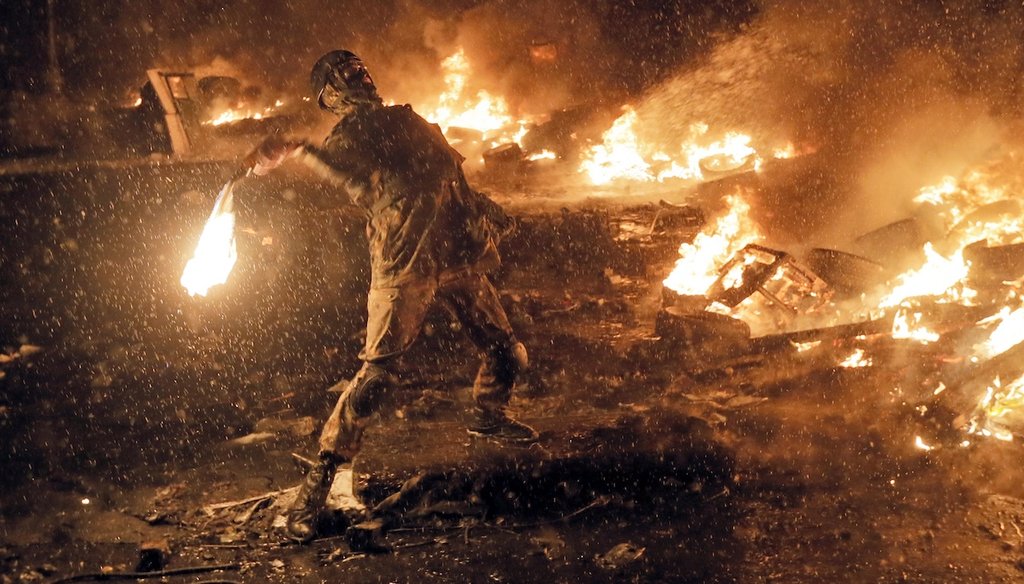 A protester throws a Molotov cocktail during clashes with police in central Kyiv, Ukraine, on Jan. 22, 2014. (AP)