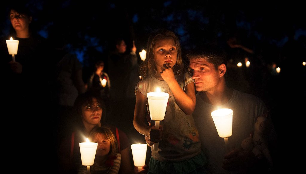 Residents honor victims of a shooting at Umpqua Community College in Roseburg, Ore.  The rampage killed nine and wounded seven. (New York Times)