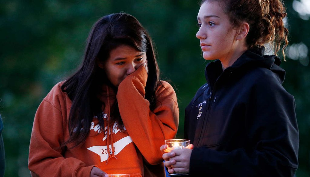 People hold candles during a prayer vigil Oct. 3, 2015, in Winston, Ore. The vigil was held in honor of the victims of the fatal shooting at Umpqua Community College. (AP)