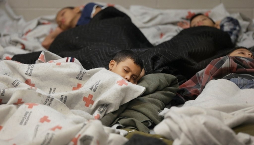 Detainees sleep in a holding cell at a U.S. Customs and Border Protection processing facility in Brownsville, Texas, on June 18, 2014.