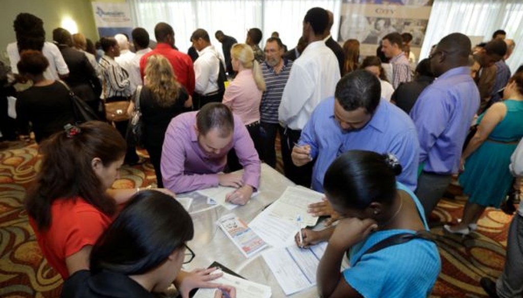 Job seekers attend a job fair in Miami Lakes, Fla., on Oct. 22, 2014.
